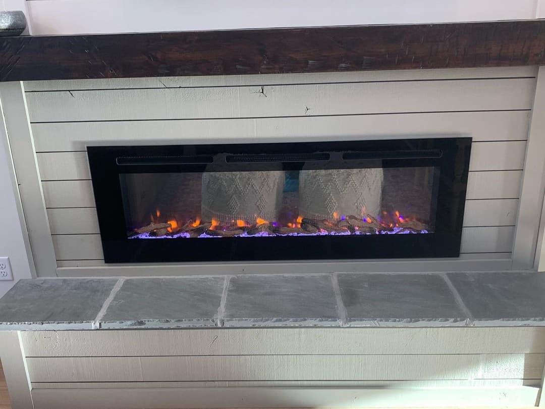 Modern electric fireplace with realistic flame effect and sleek black frame.