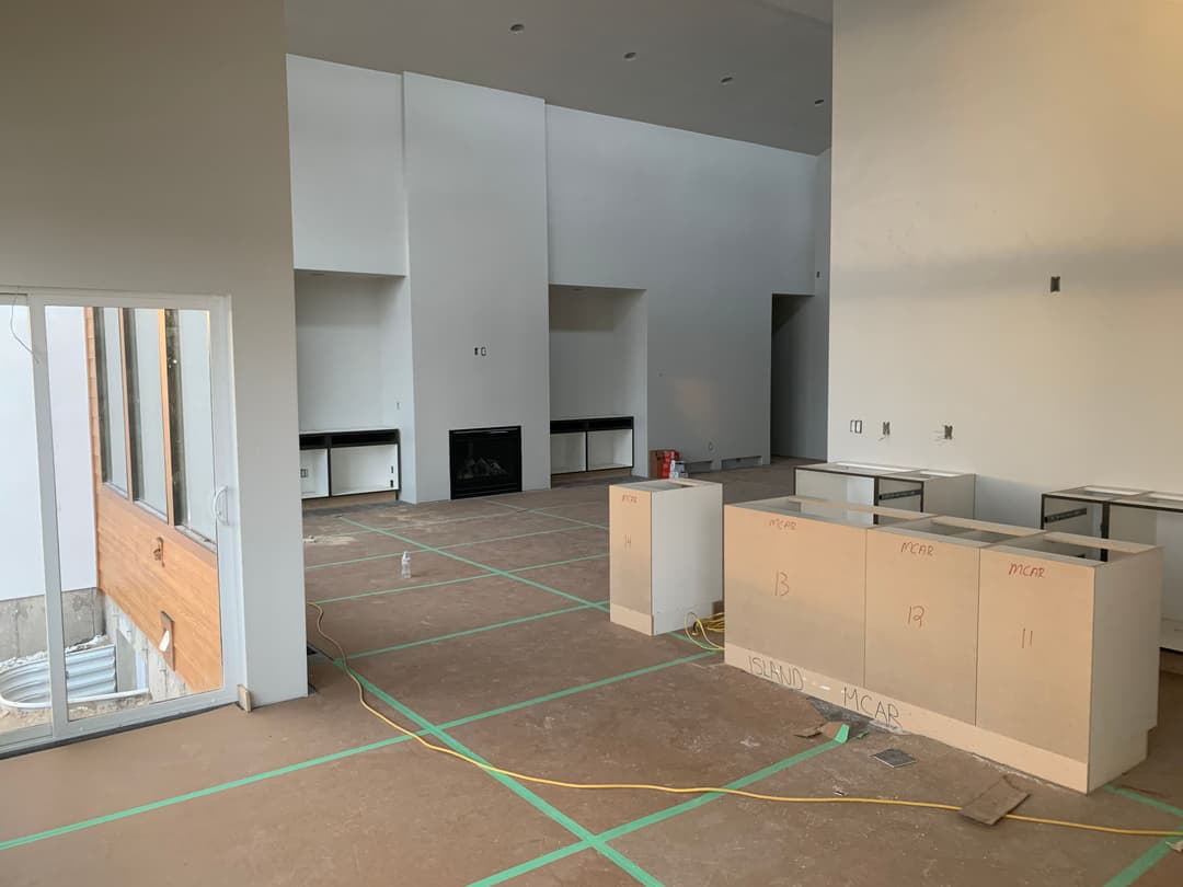 Newly constructed interior space with framed walls and a fireplace ready for finishing touches.