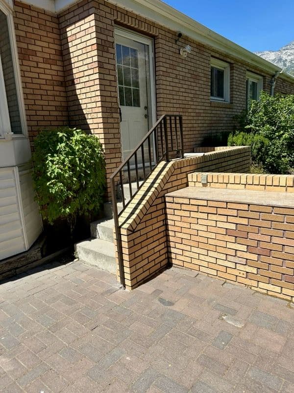 Brick Patio Upgrade with Elegant Metal Railing image